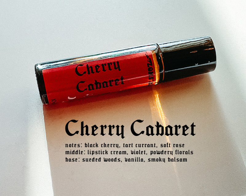 Roll-on bottle of Cherry Cabaret perfume with description on a white background
