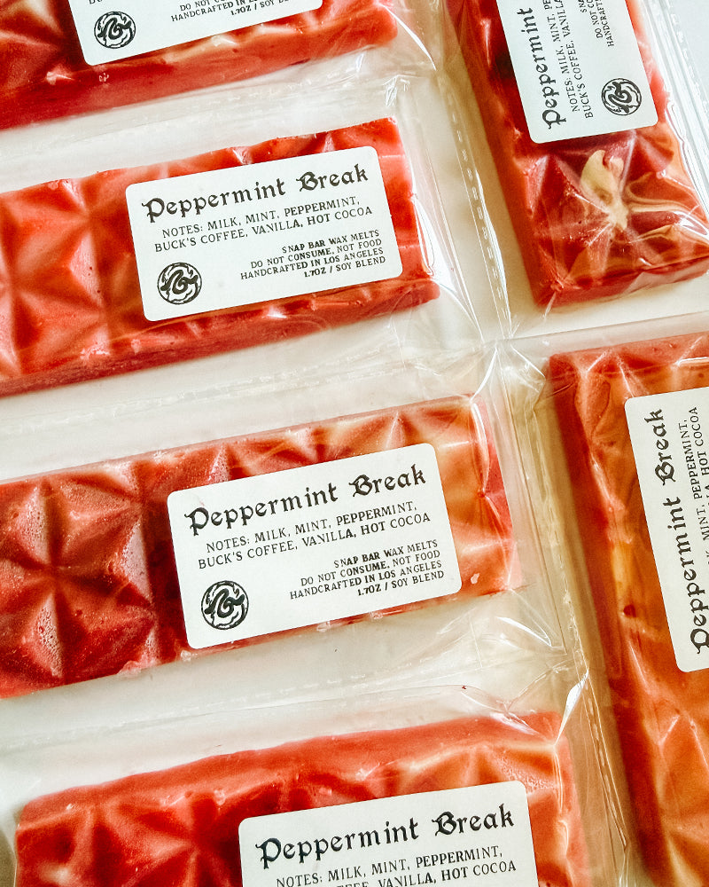 Red wax melts labeled 'Peppermint Break' on a white background