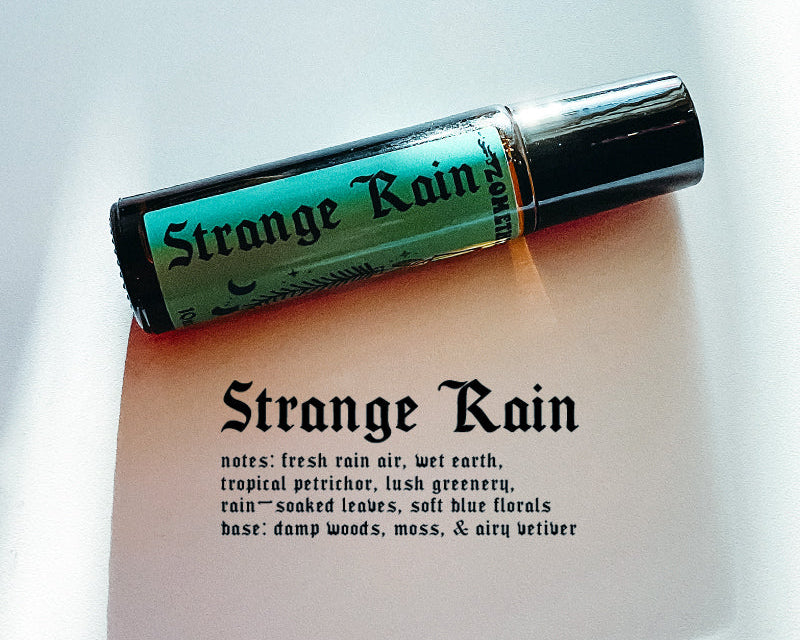 Roll-on bottle labeled 'Strange Rain' on a white background