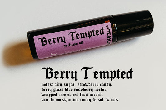 Roll-on perfume bottle labeled 'Berry Tempted' on a light gray background