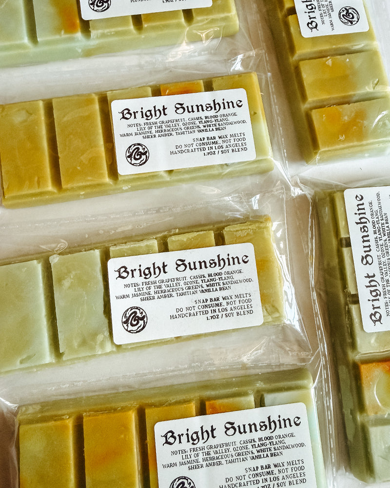 Multiple bars of wax melts labeled 'Bright Sunshine' in clear packaging.