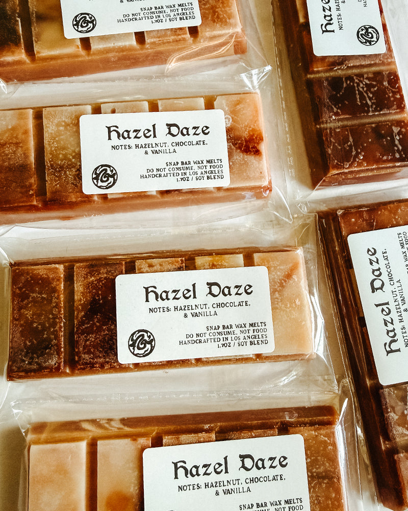 Multiple bars of Hazel Daze wax bars in packaging with visible branding.