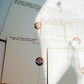 A set of cream-colored stationery cards featuring printed quotes by famous thinkers such as Jean Guizot, Tony Ross, and Steve Harvey Thorne, decorated with circular metallic foil seals.