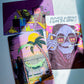 Three colorful art prints featuring surreal, horror-themed illustrations are arranged on a light blue surface with natural sunlight casting shadows. The prints depict a character in a black robe holding a cup next to a hammock, a character in a lab coat looking at a brain, and a skull wearing sunglasses with the text 'FUTURE'S SO BRIGHT, I GOTTA DIG GRAVES'.