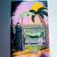A colorful art print or card featuring a grim reaper holding a scythe next to a hammock with a skull, under a yellow sun and palm tree, photographed against a light gray background with shadows.