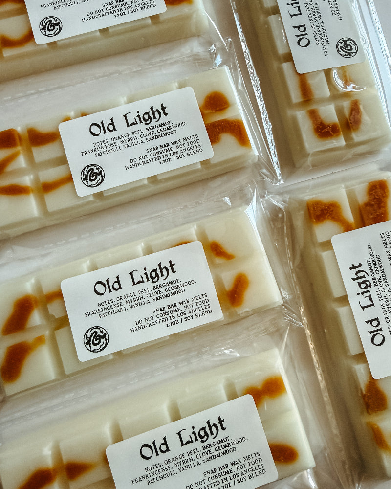 Packaged wax bars with 'Old Light' label on a white background