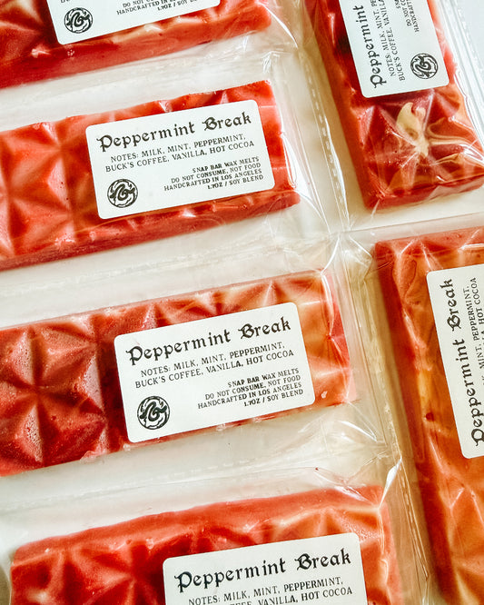 Red wax melts labeled 'Peppermint Break' on a white background