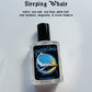 Perfume bottle labeled 'Sleeping Whale' with whale illustration on a white background