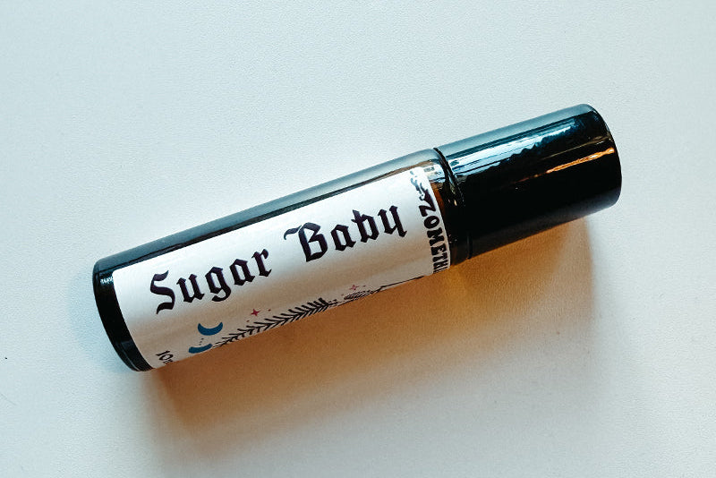 Roll-on bottle labeled 'Sugar Baby' on a light background