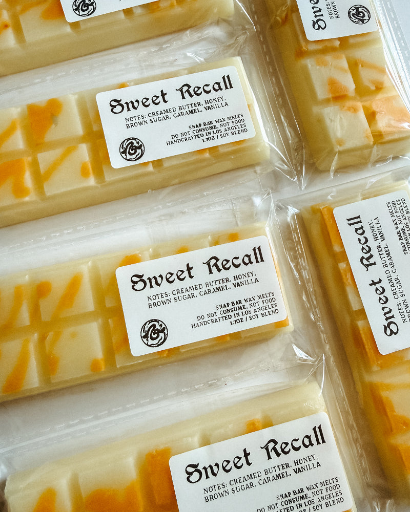 Multiple packages of 'Sweet Recall' wax melts with visible branding.