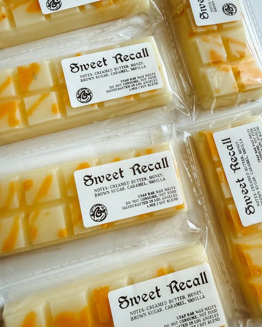 Multiple packages of 'Sweet Recall' wax melts with visible branding.
